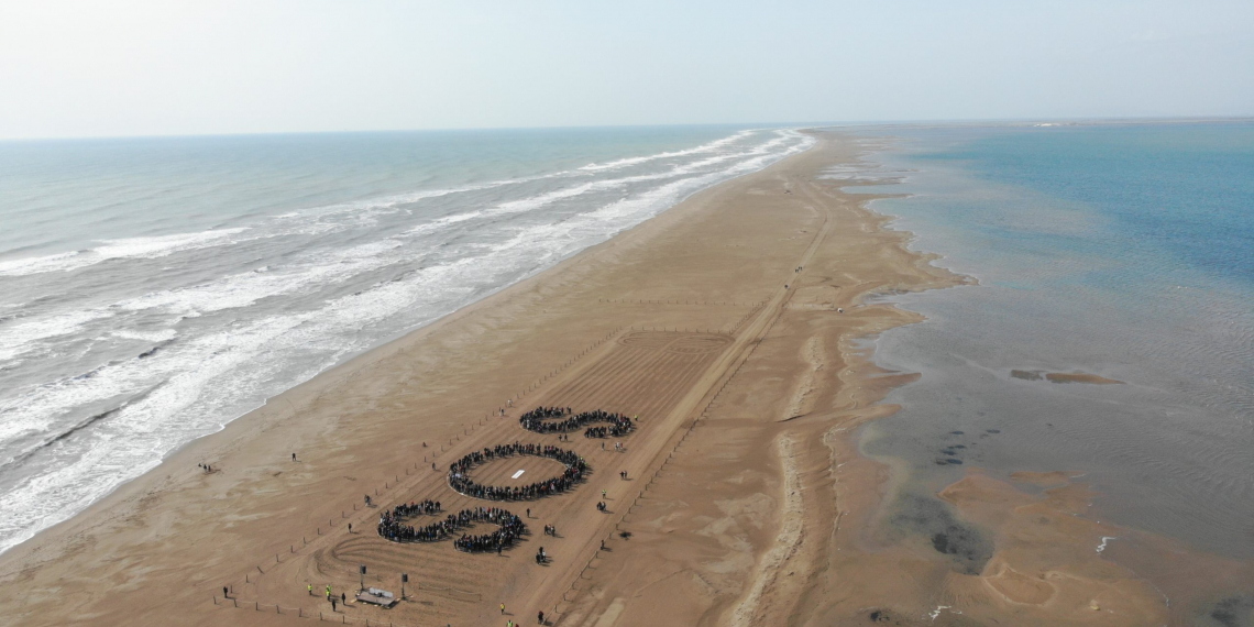 Centenars de persones formen les lletres SOS a la platja del Trabucador